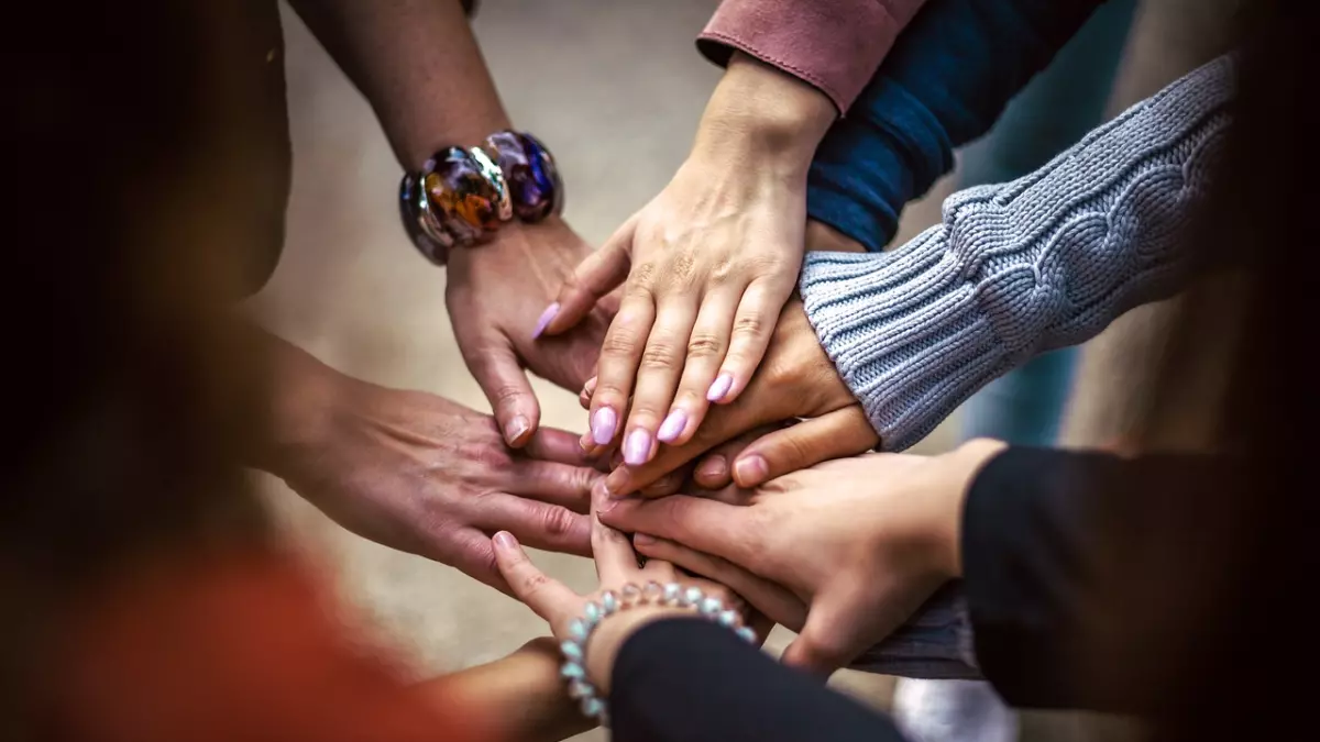 Hands clasped together in a circle.