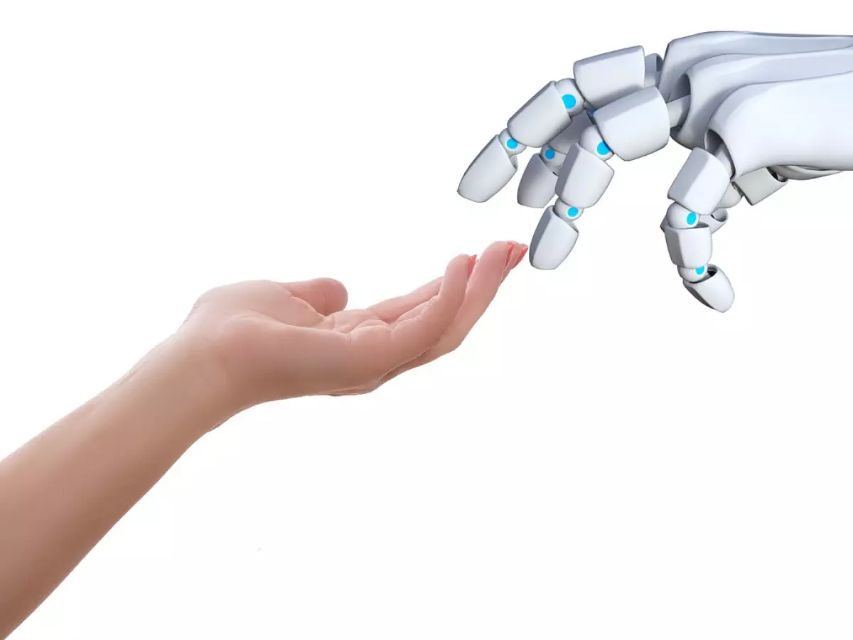 A human hand and a robotic hand are reaching out to each other, creating a sense of connection and collaboration.