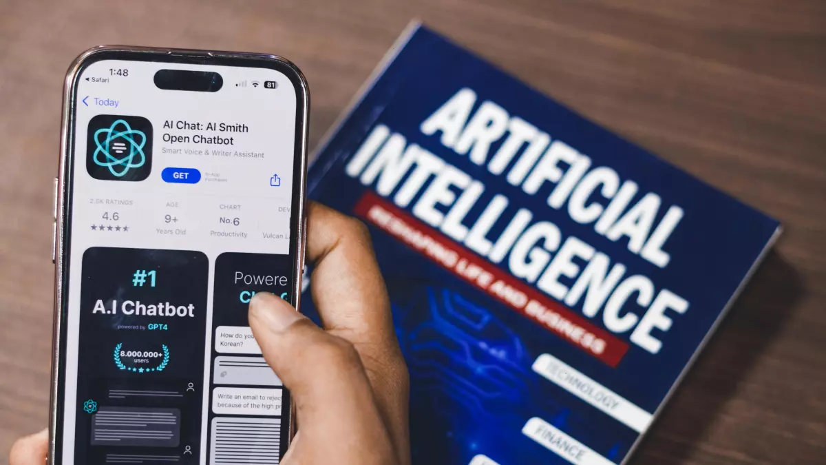 A hand holds a smartphone displaying an AI chatbot app on the screen, with a book titled 