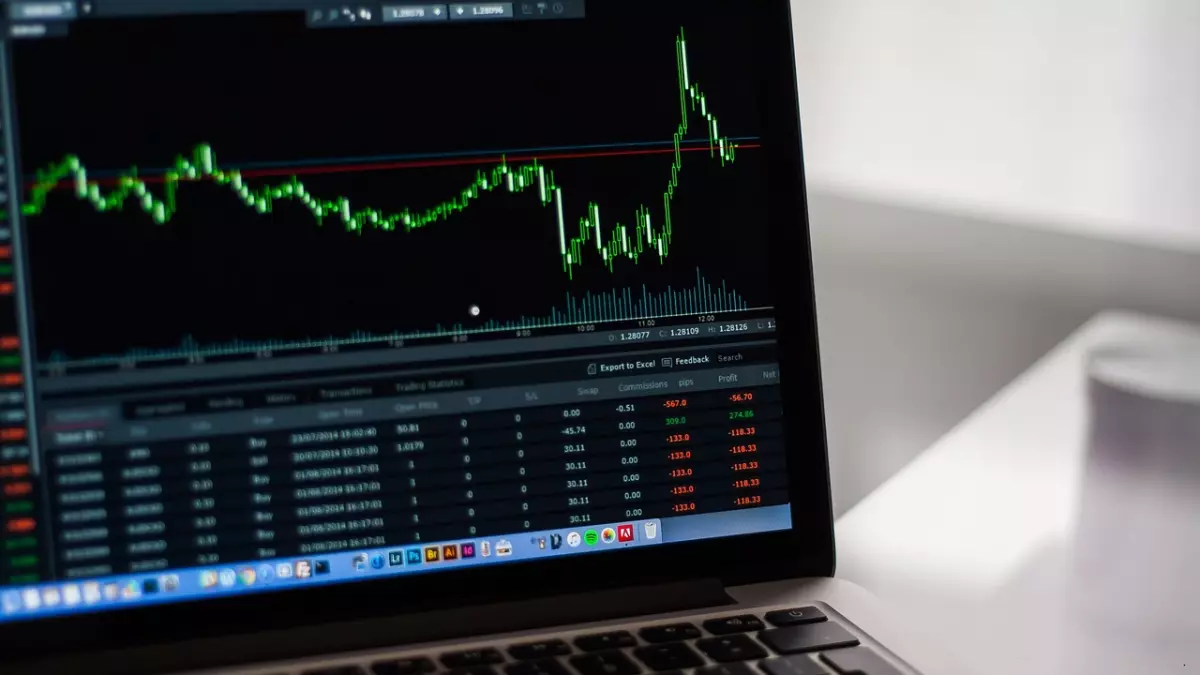 A laptop screen displaying a stock market graph with a sharp upward trend, indicating significant growth in the tech sector.