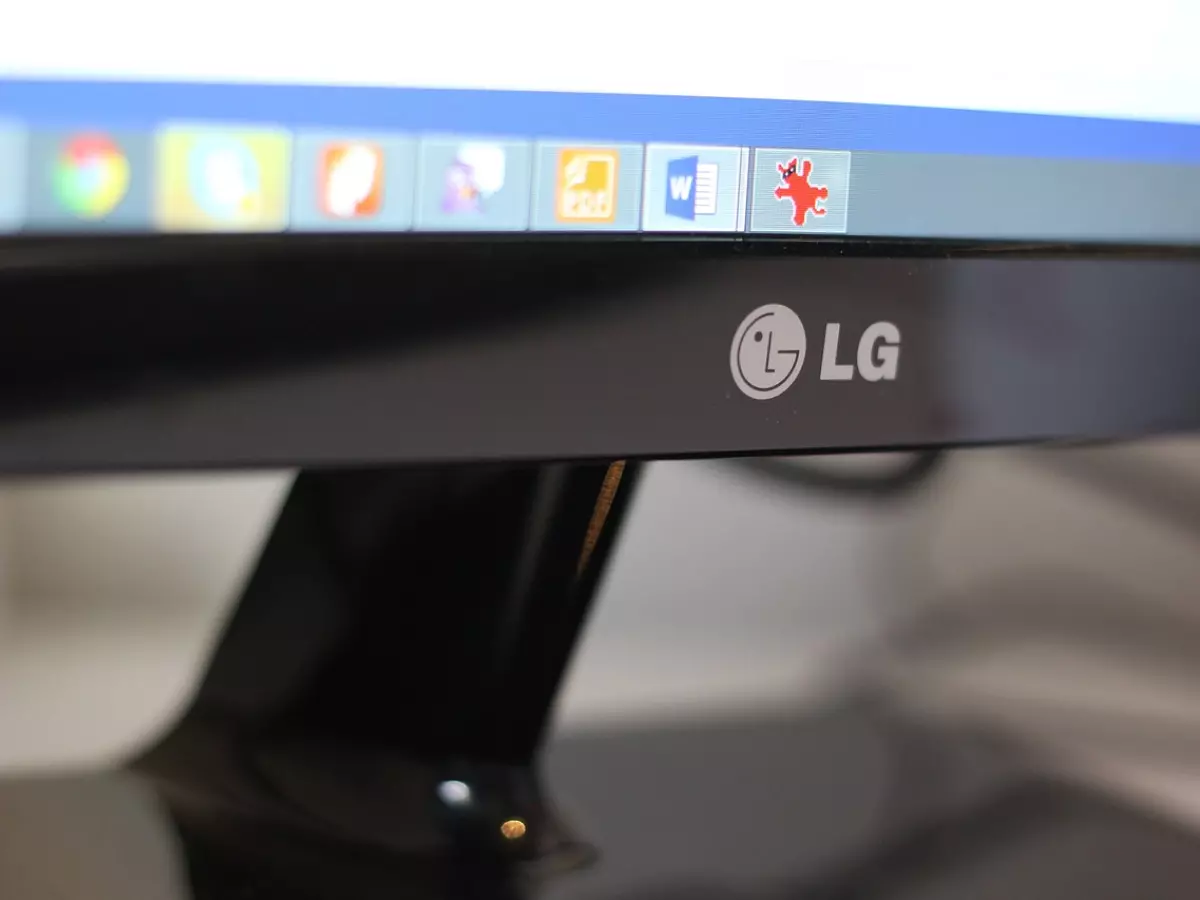 A close-up shot of a computer monitor with a cursor hovering over a folder icon and other icons in the taskbar.