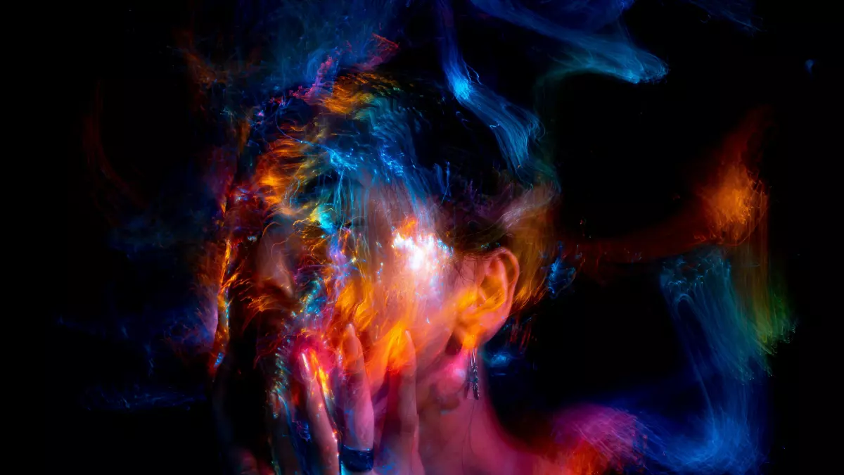 Abstract portrait of a face with colorful, textured elements resembling digital noise or a rendering process.