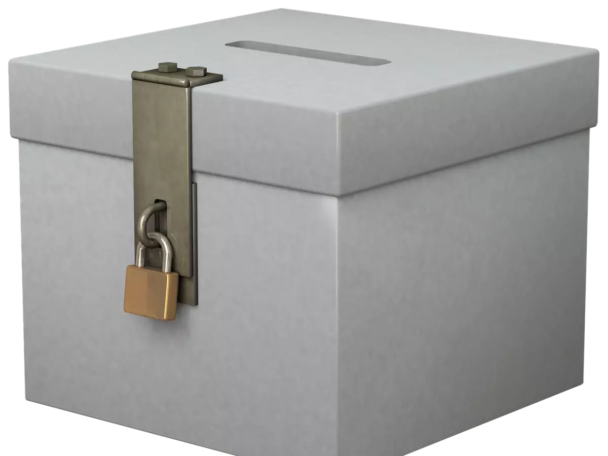 A white ballot box with a silver lock and a brass padlock.