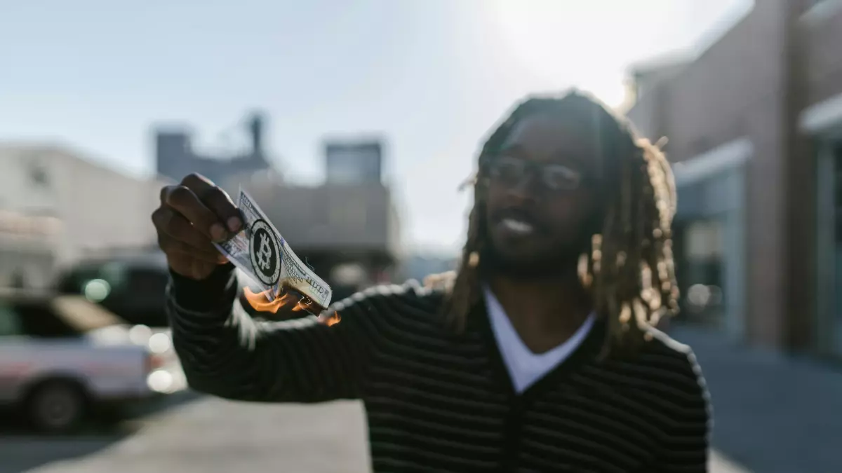 A man with dreadlocks smiling while holding something in his hand.