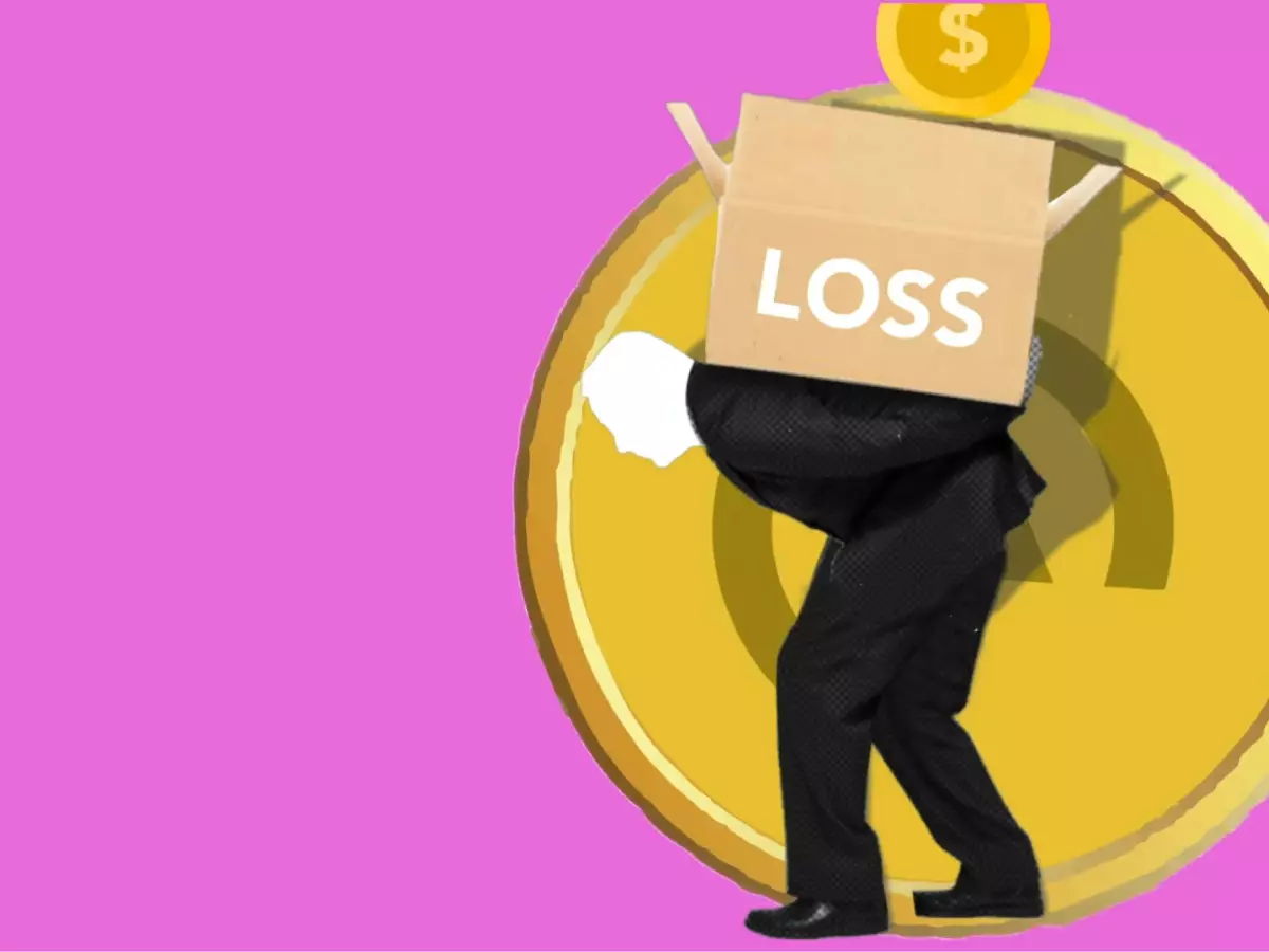 A person in a suit is carrying a box labeled 'Loss' on their back, standing on a large gold coin with a dollar sign on it.