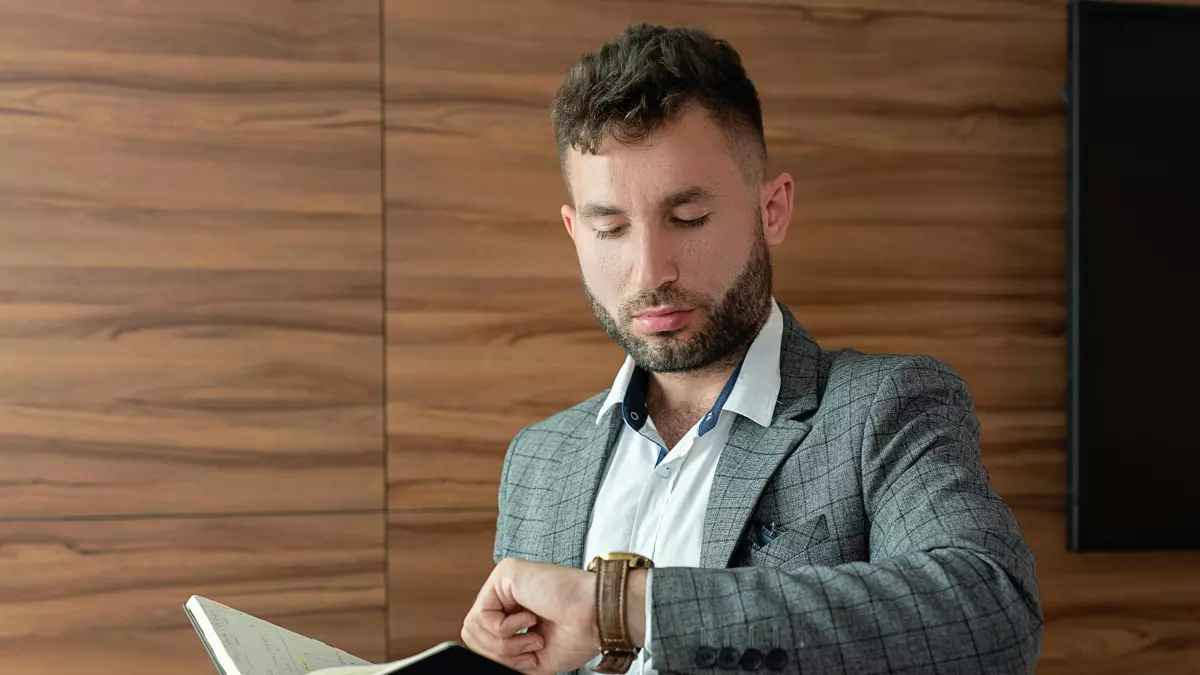 A man looking intently at his smartwatch.