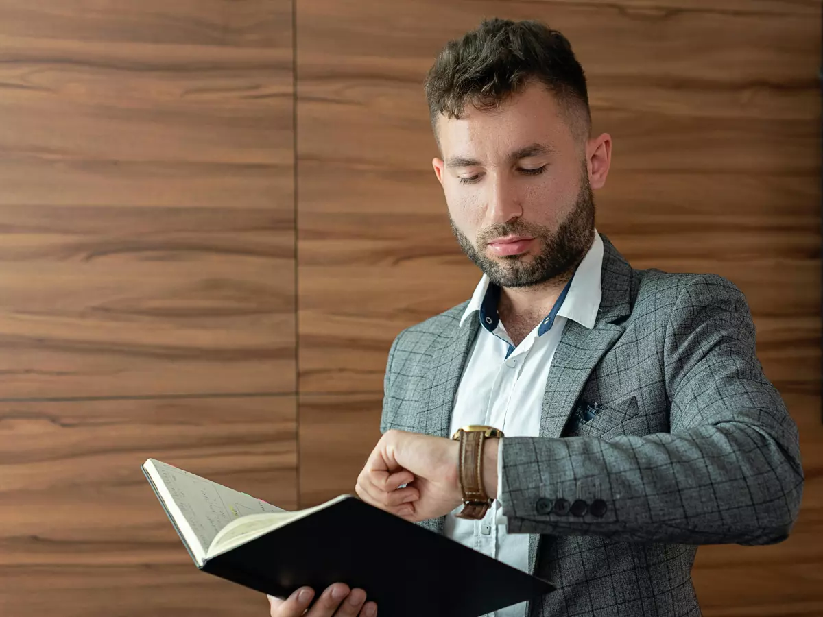 A man looking intently at his smartwatch.