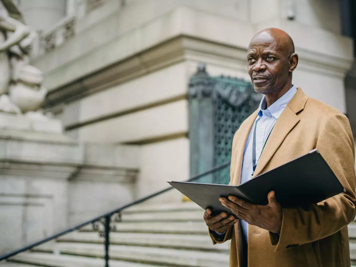 A man in a suit looking thoughtfully into the distance