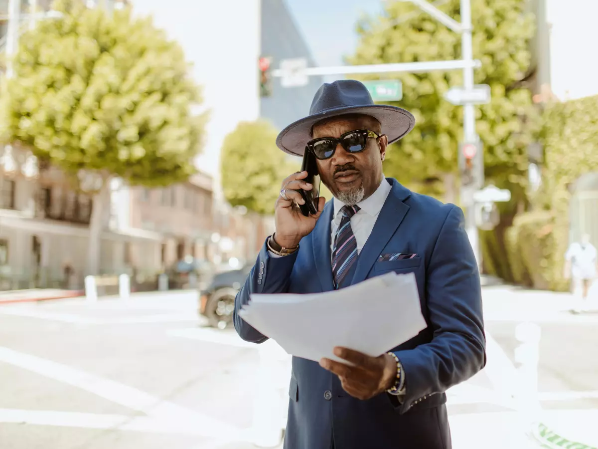 A man in a suit is talking on his phone.