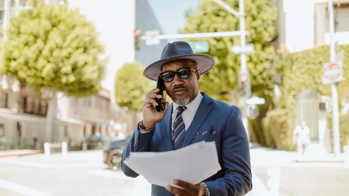 A man in a suit is talking on his phone.