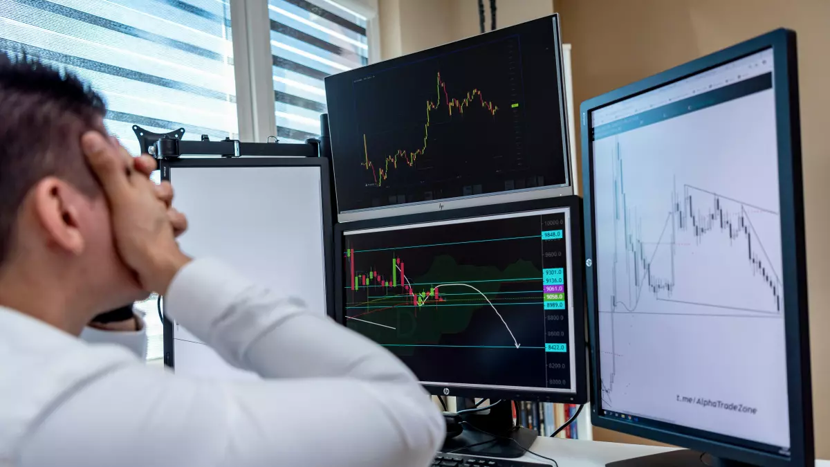 A person looking intently at multiple computer screens displaying stock market graphs, highlighting the volatility and complexity of tech stock investments.