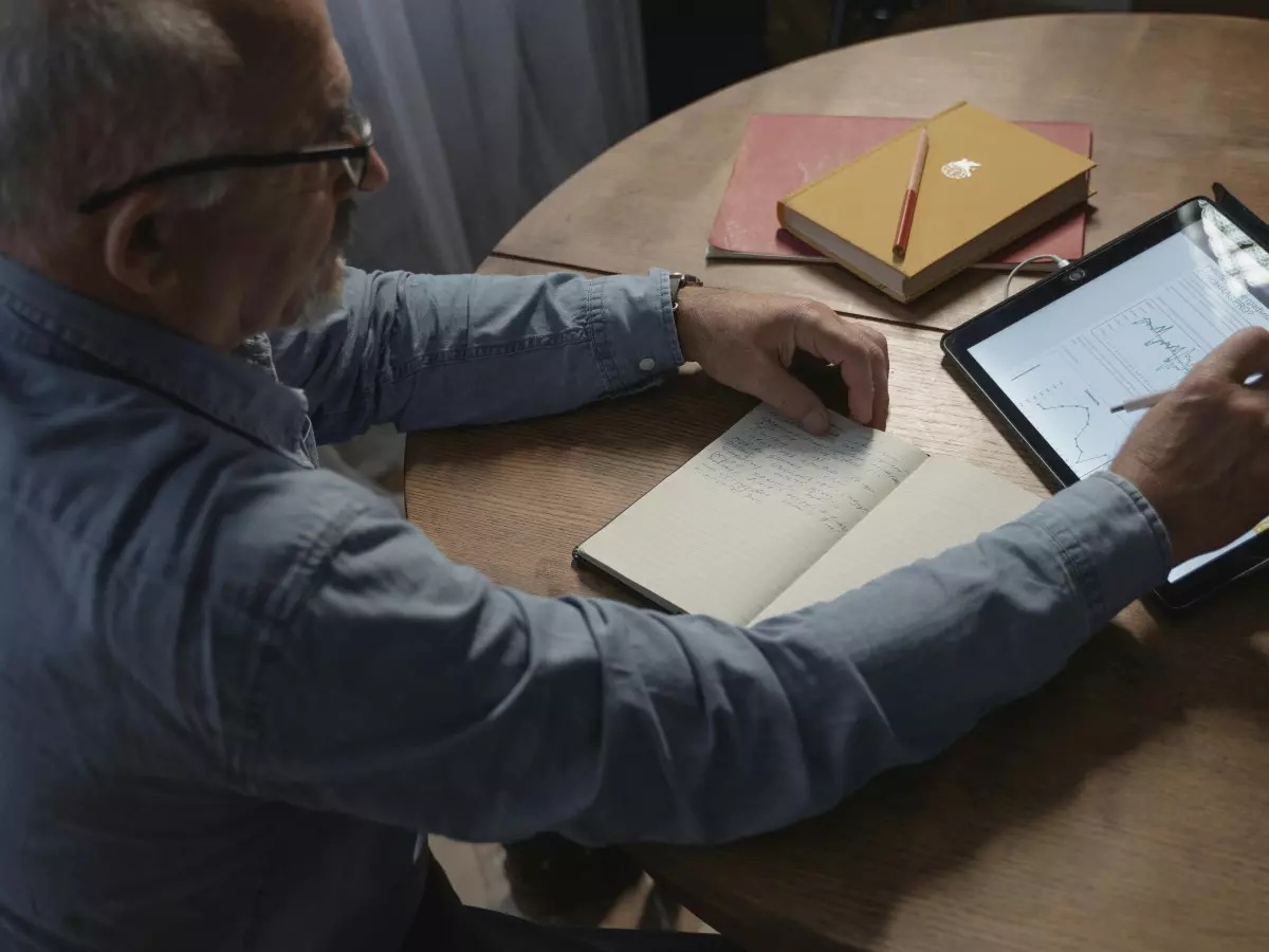 A man reading on a tablet.