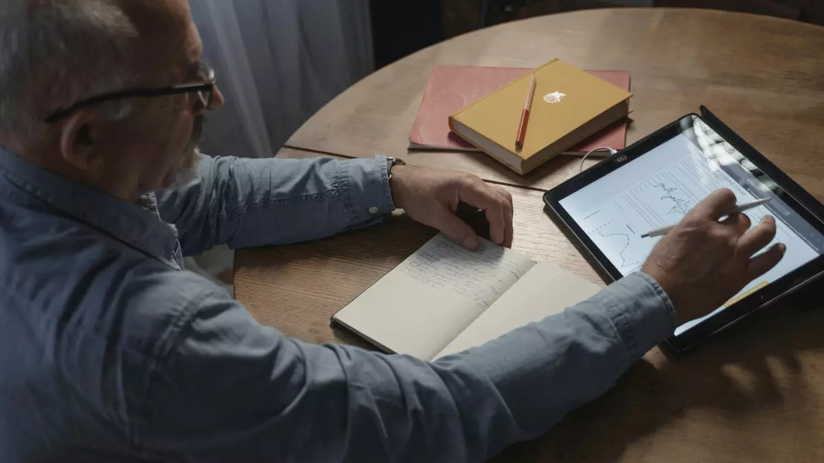 A man reading on a tablet.