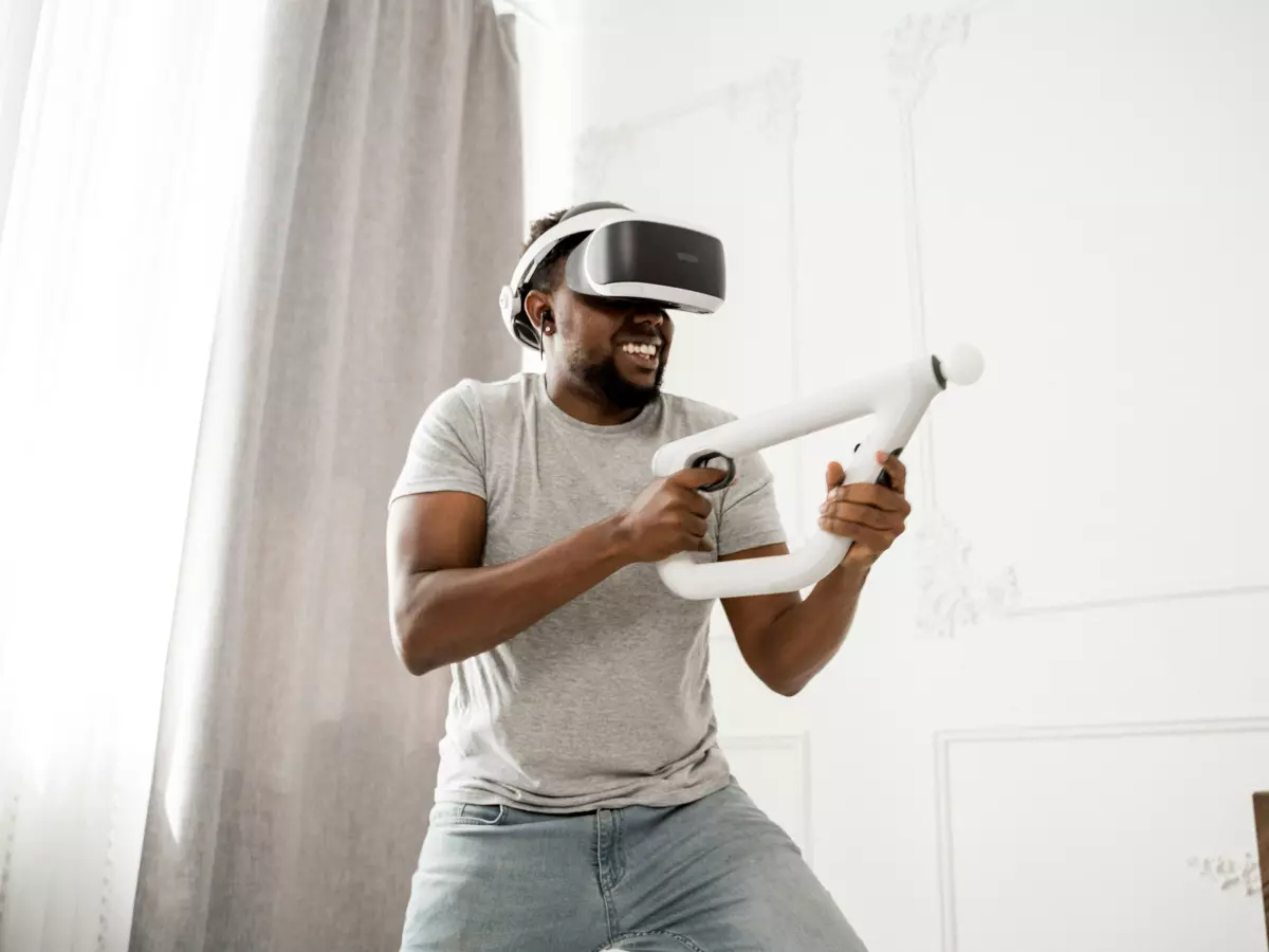 A person is playing a VR game using a VR headset and controllers.