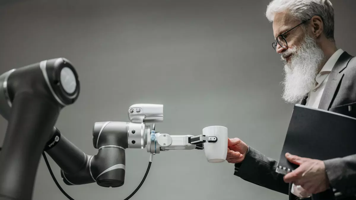 A robotic arm with multiple joints interacts with a human, holding a piece of paper, showcasing the integration of robotics and human interaction.