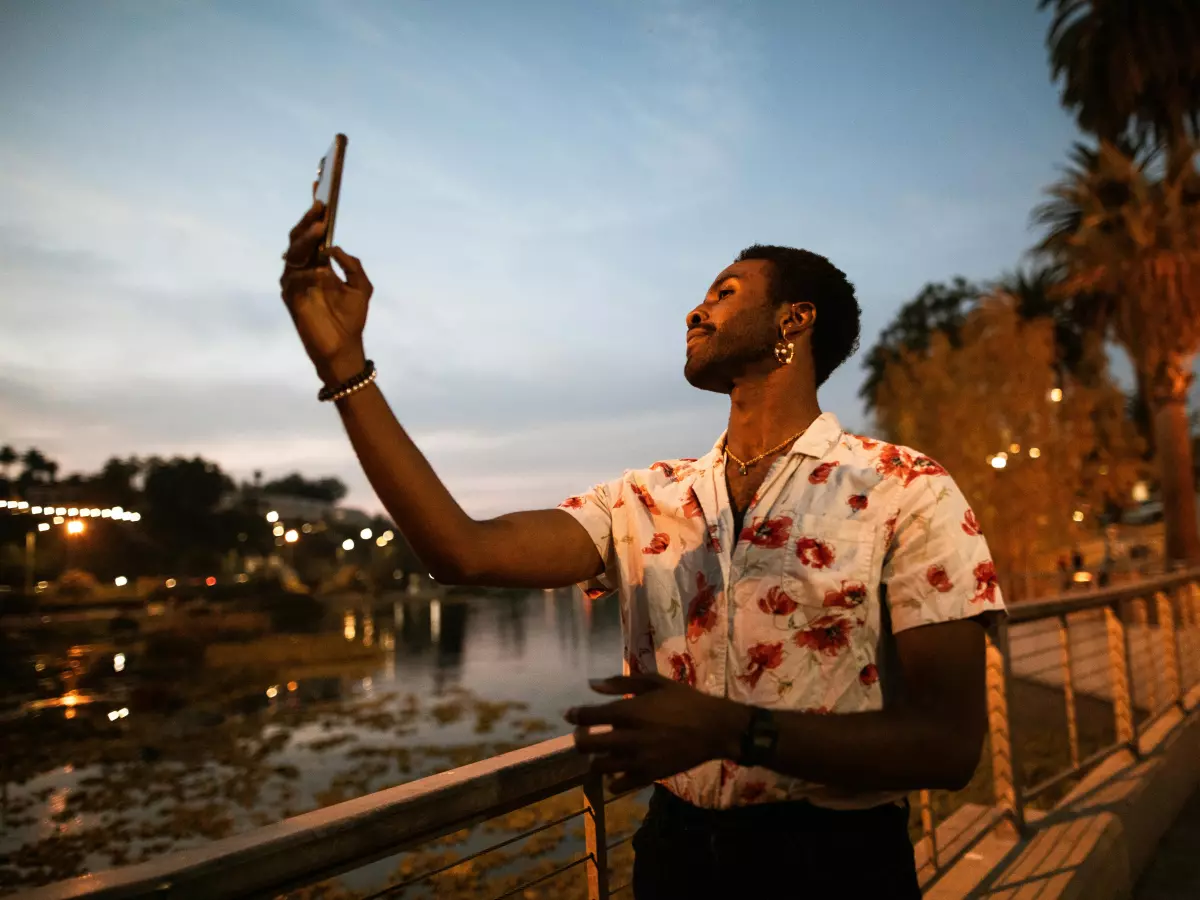 A person is taking a selfie with a smartphone.