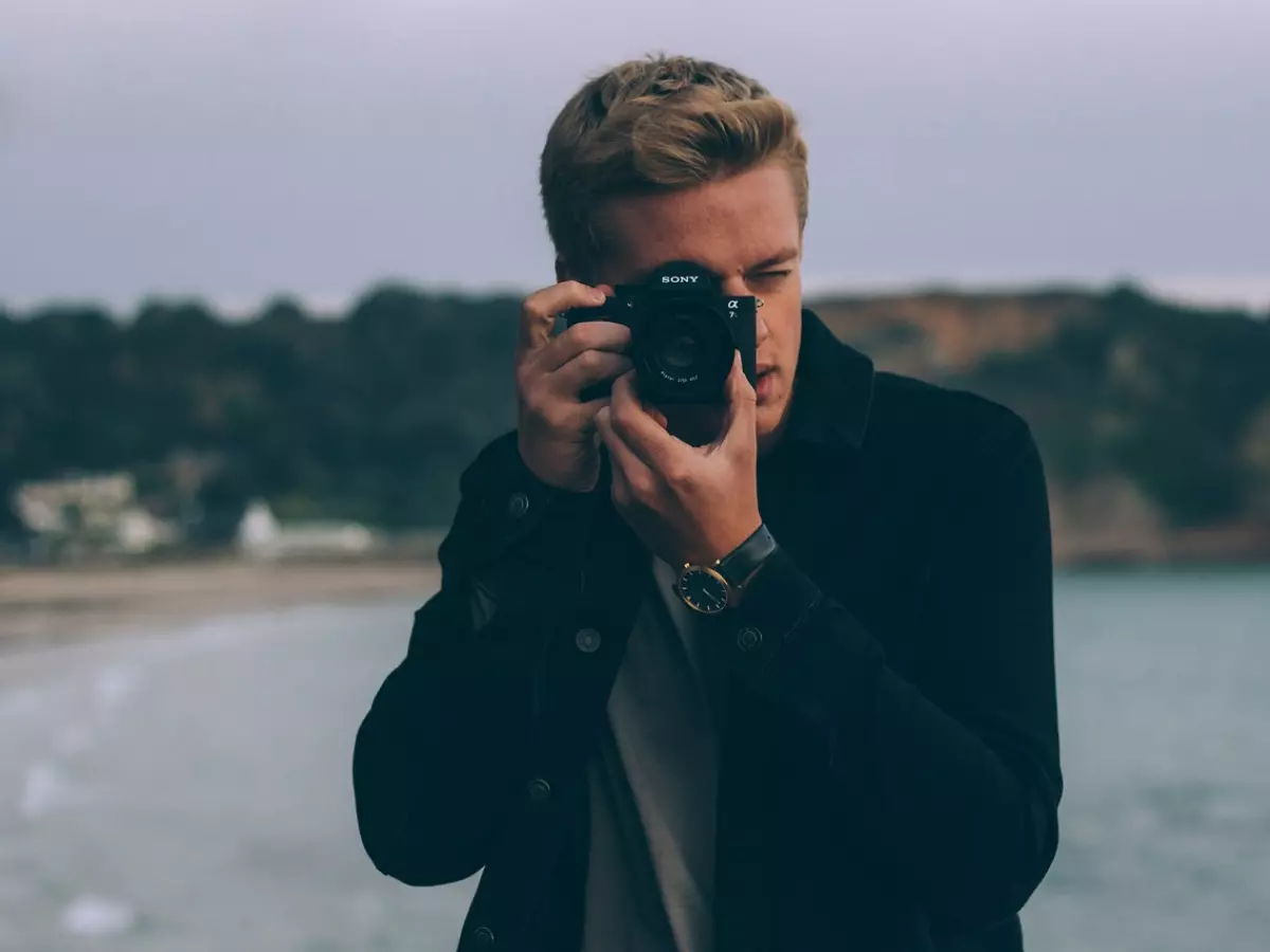 A man is taking a photo with a Sony camera.