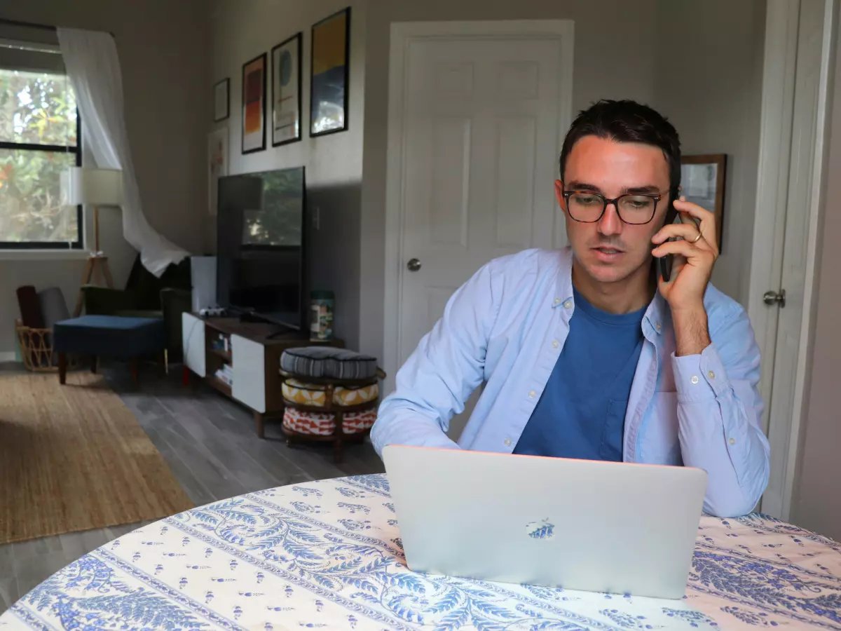 A person using a laptop in a home office setting