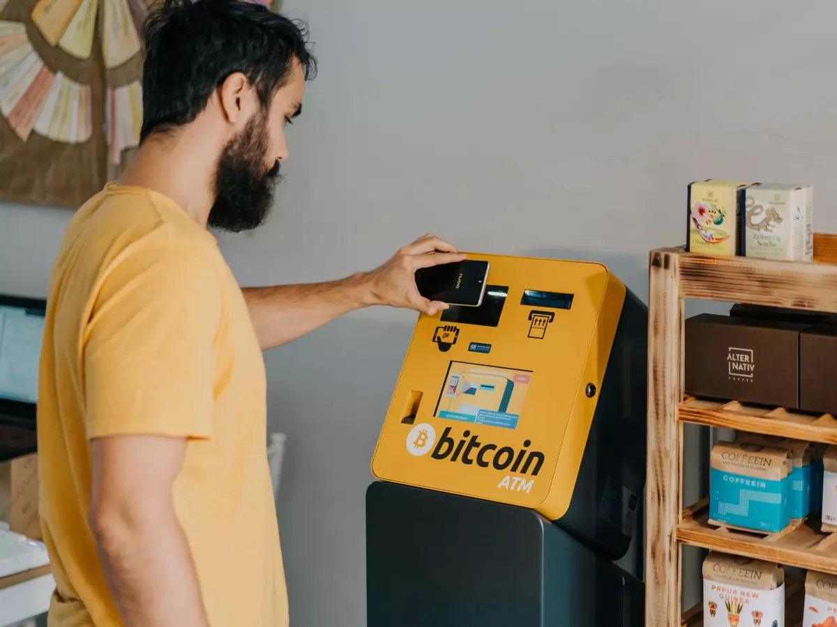 A man is using a bitcoin ATM.