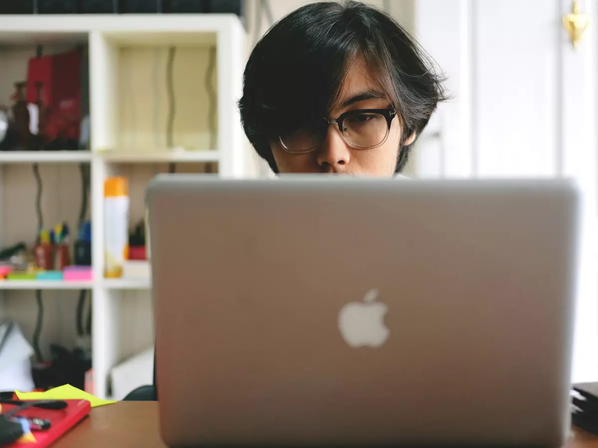 A person is working on a laptop in a room.