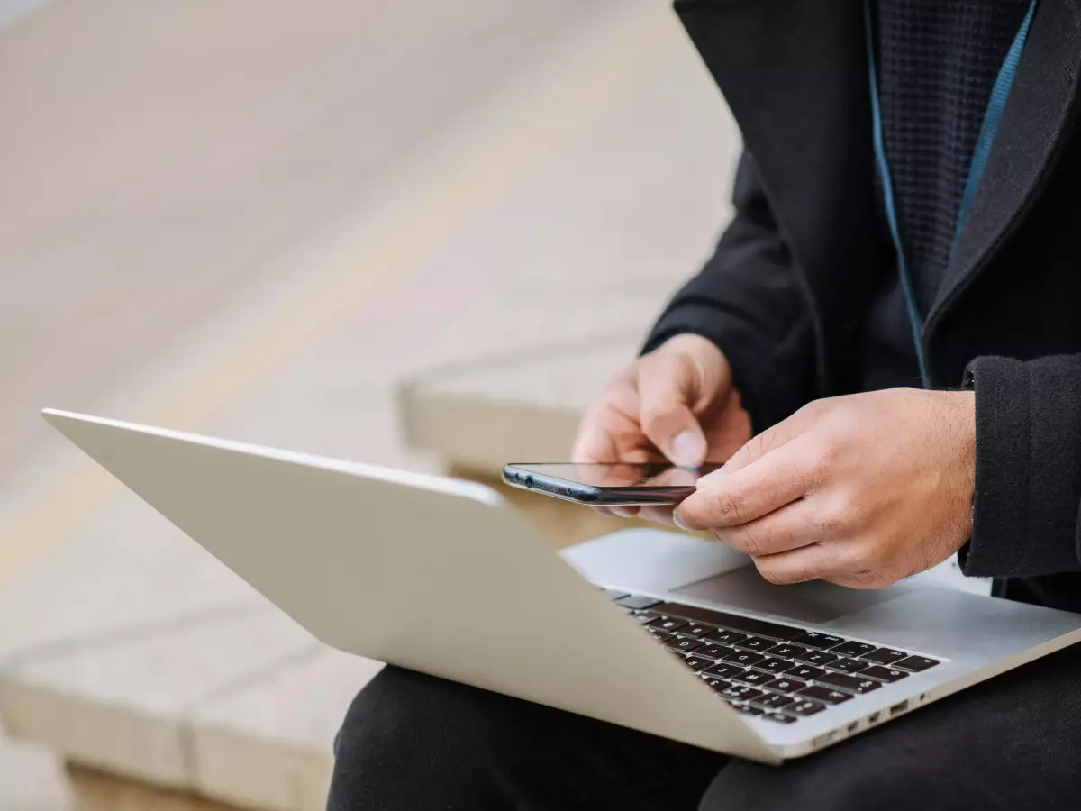 A person sitting at a desk, working on a laptop.