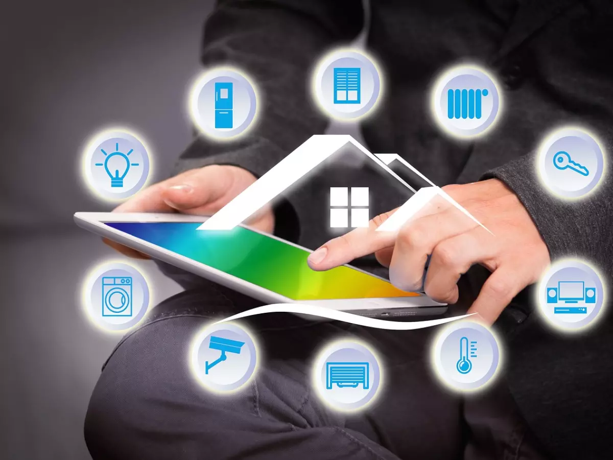 A person using a tablet to control various aspects of their smart home. Icons representing smart home devices surround the tablet, creating a visual representation of connectivity.