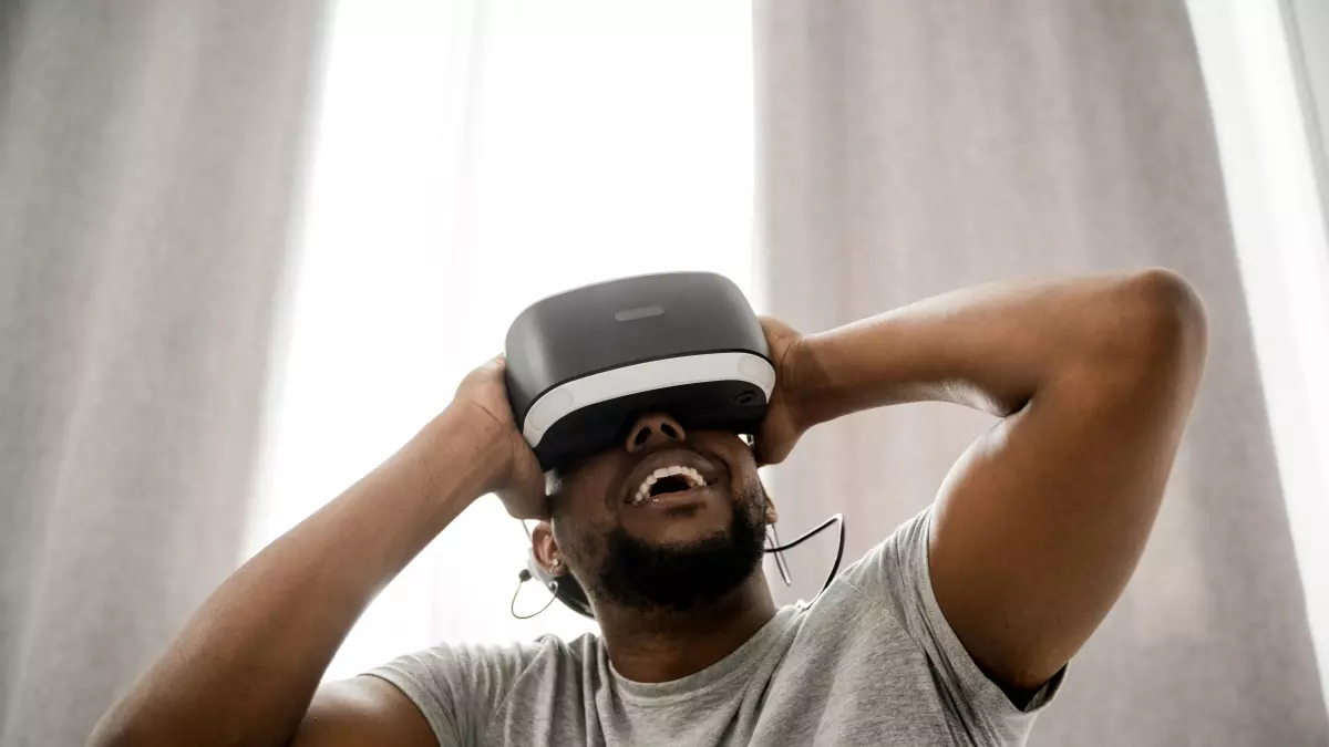 A man wearing a VR headset looks surprised and possibly overwhelmed by the experience.