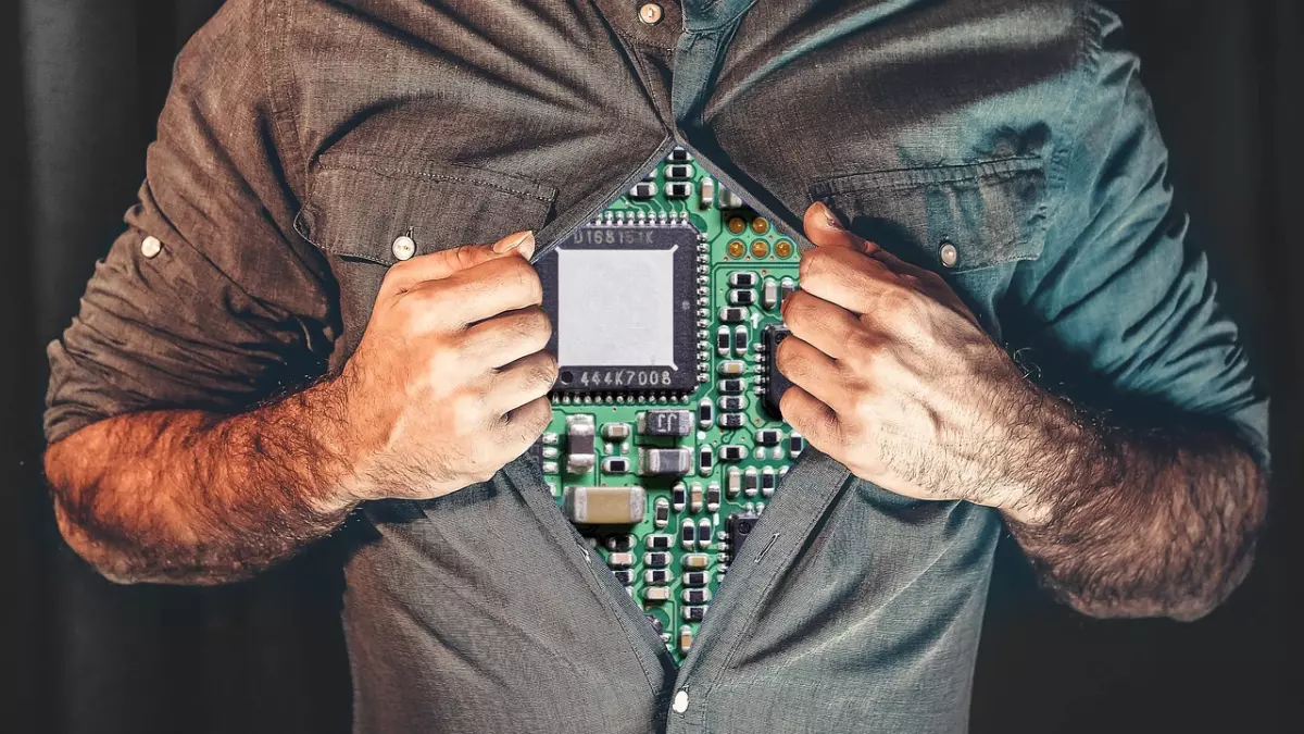 A man with a torn shirt revealing a circuit board, symbolizing the integration of technology within the human body. The image evokes a sense of wonder and mystery.