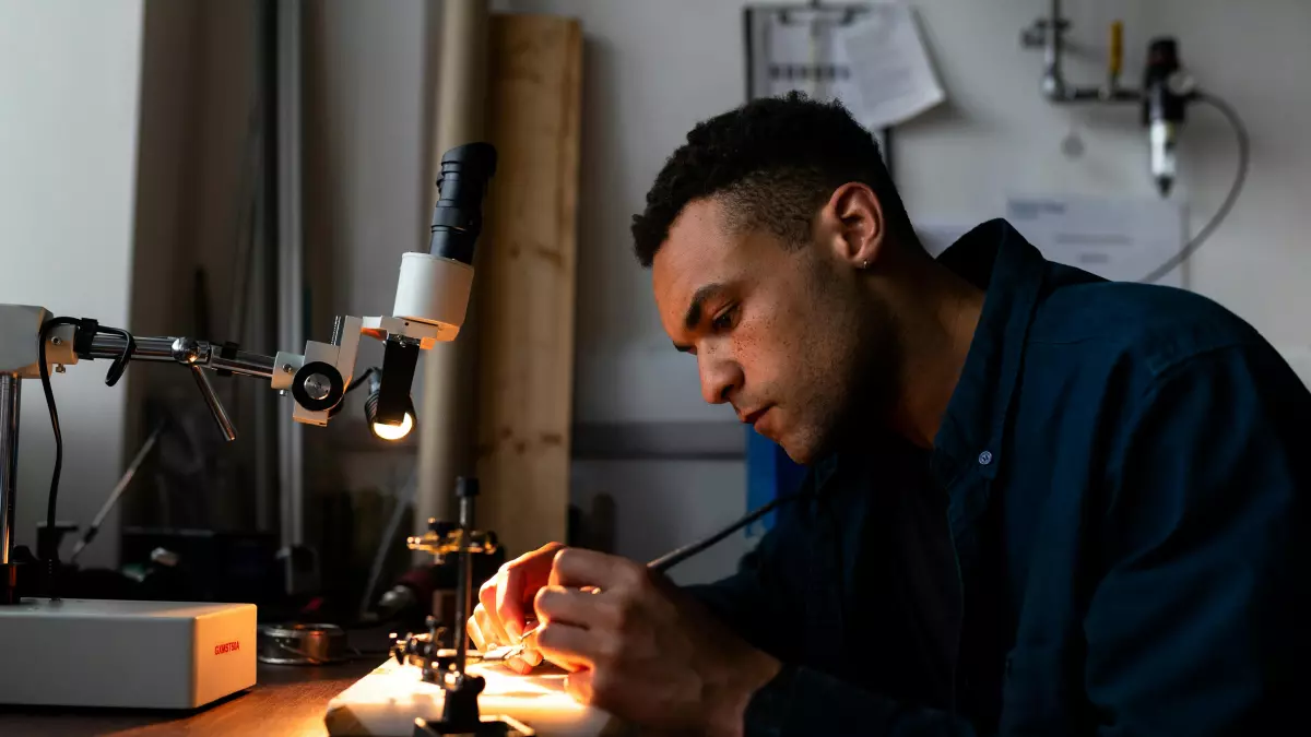 A person soldering a circuit board