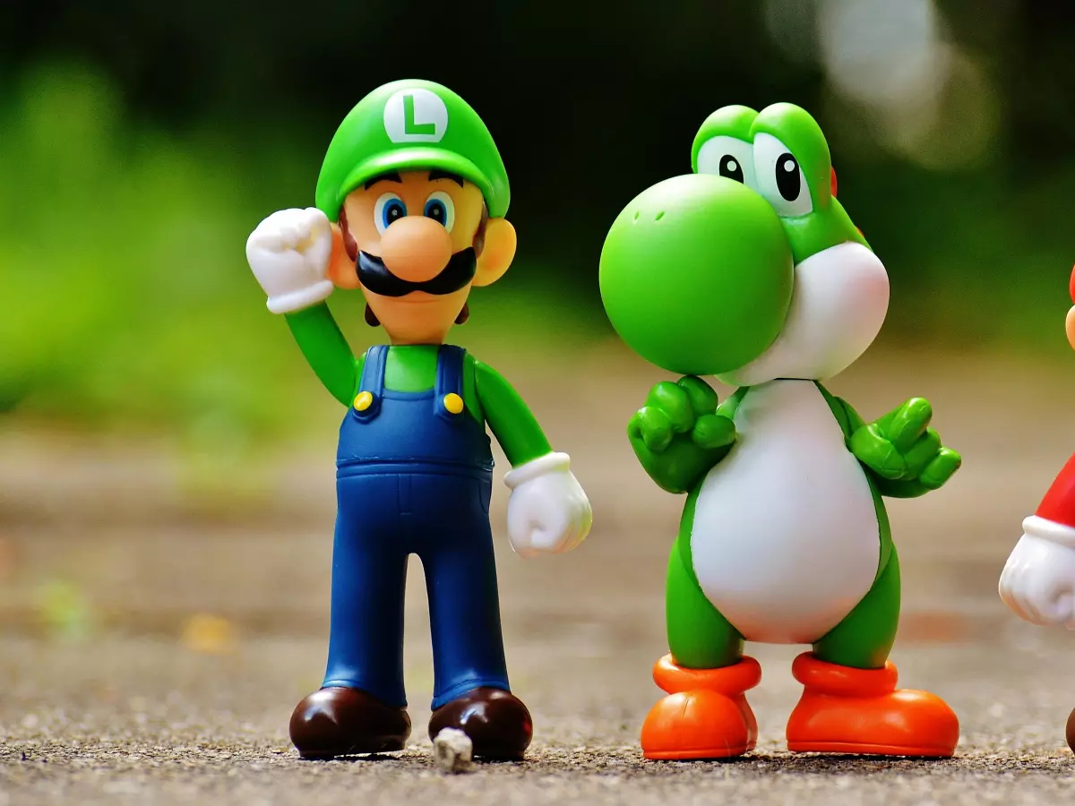 Mario, Luigi, and Yoshi figurines standing on a sidewalk