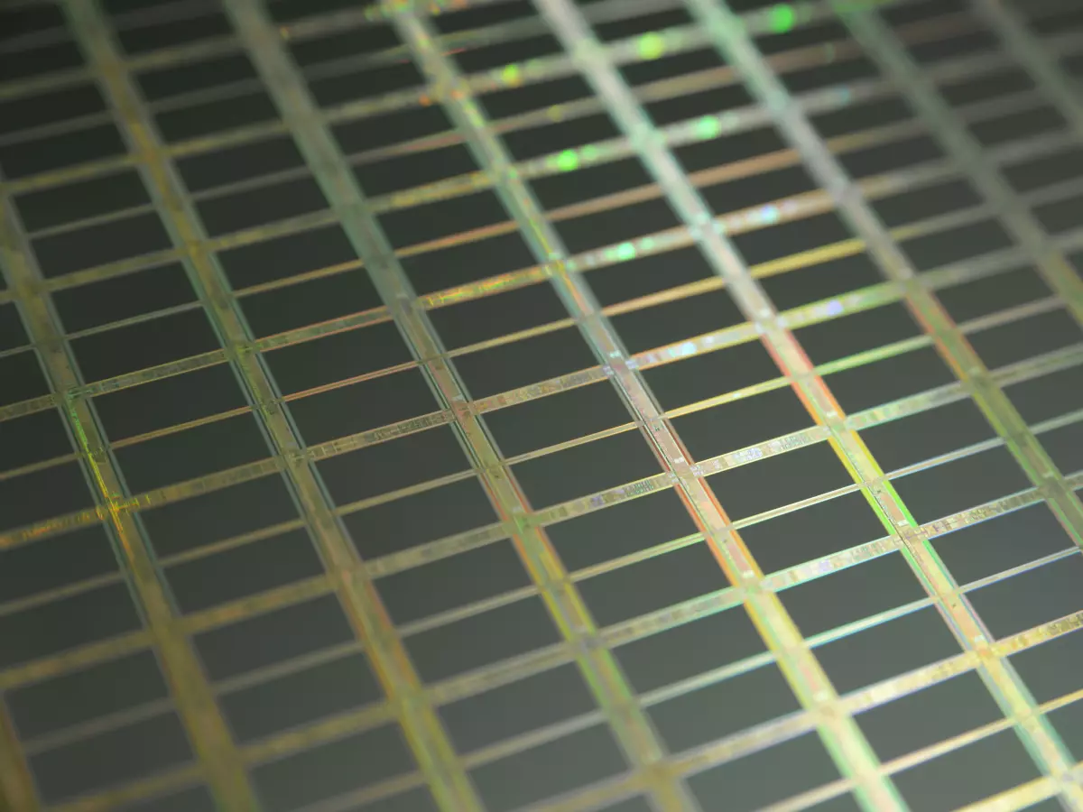 Close-up image of a silicon wafer with a grid pattern.