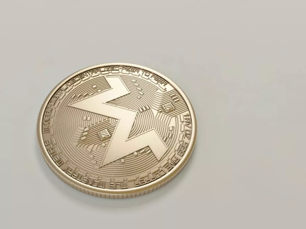 A close-up of a silver-colored coin with the TON blockchain logo.