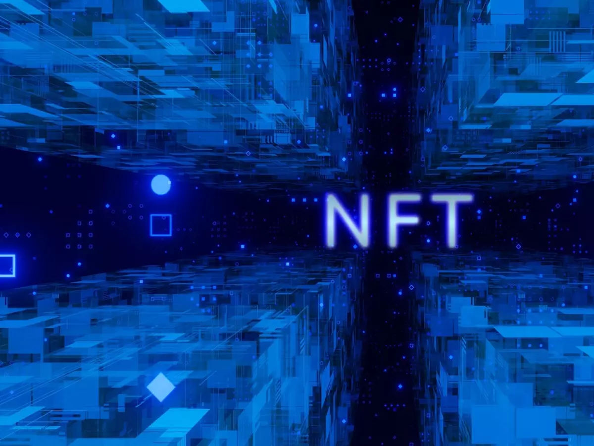 An abstract digital background with the word "NFT" in the center, surrounded by a blue and black grid of glowing lights.