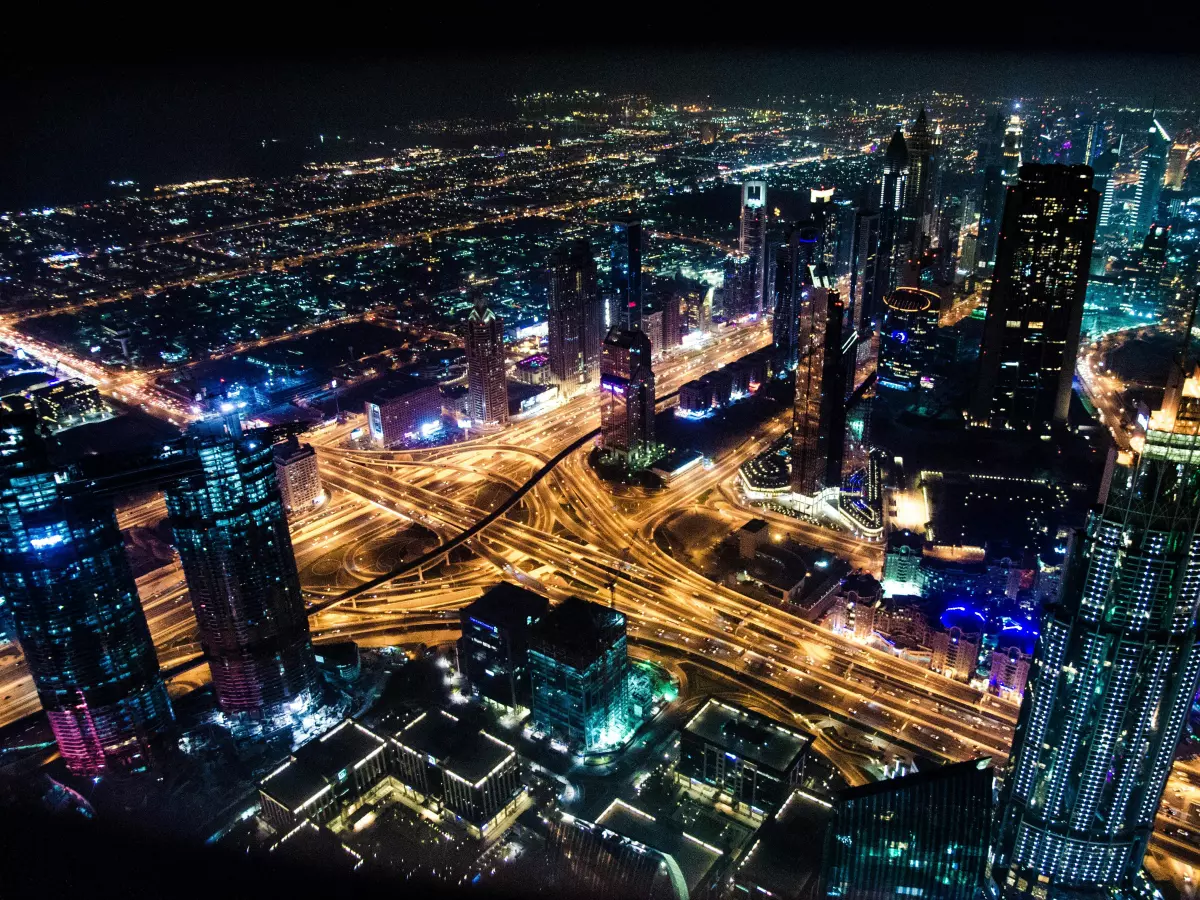 A night cityscape with lights illuminating buildings and roads, with a focus on the complexity of the city.