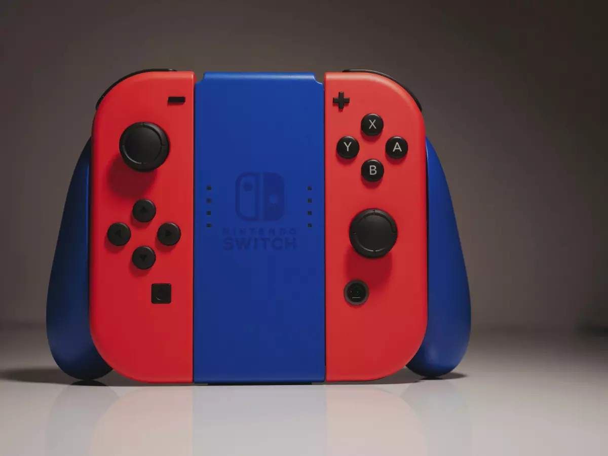 A pair of Nintendo Switch Joy-Con controllers, one red and one blue, attached to the console, showcasing the design and color scheme. The image is taken from a front view, highlighting the buttons and joysticks.