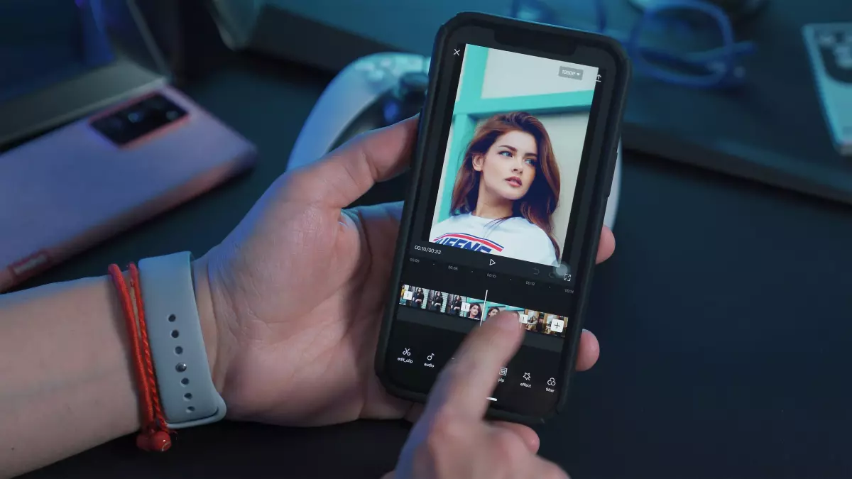 A person uses a smartphone to edit a video, showcasing AI-powered features like trimming and effects.