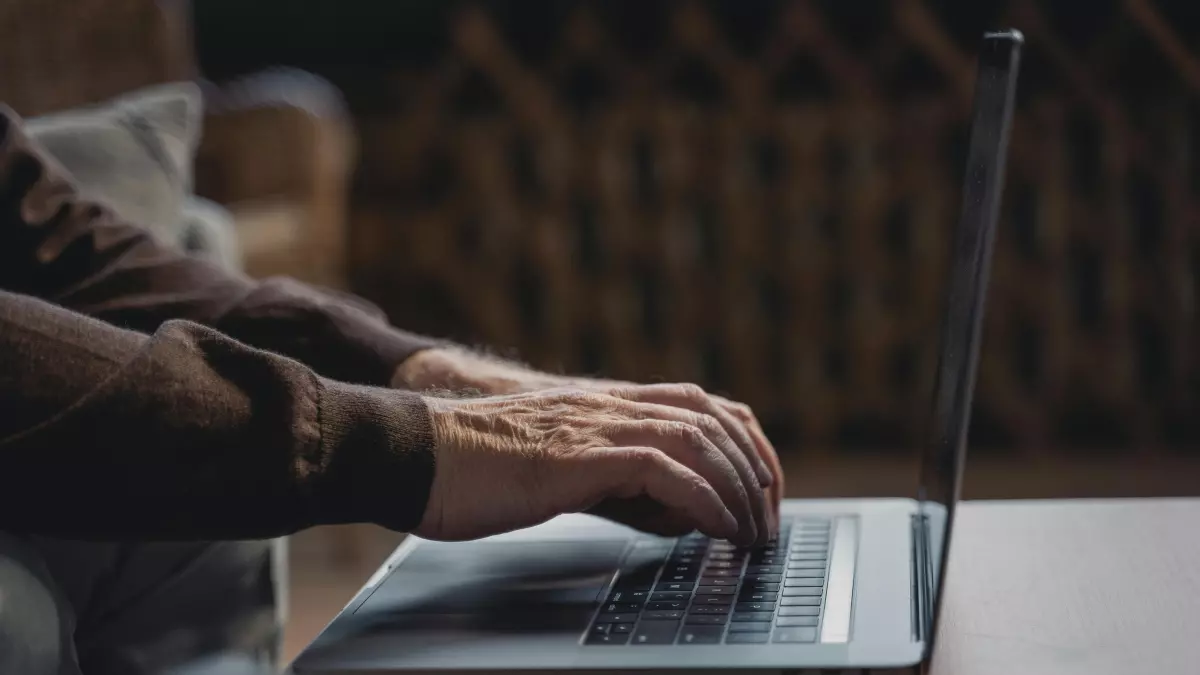 A person is working on a laptop on a table.