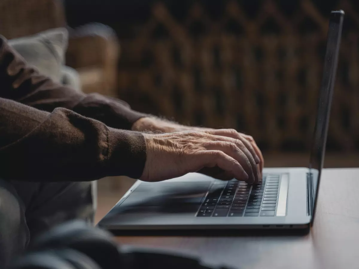 A person is working on a laptop on a table.