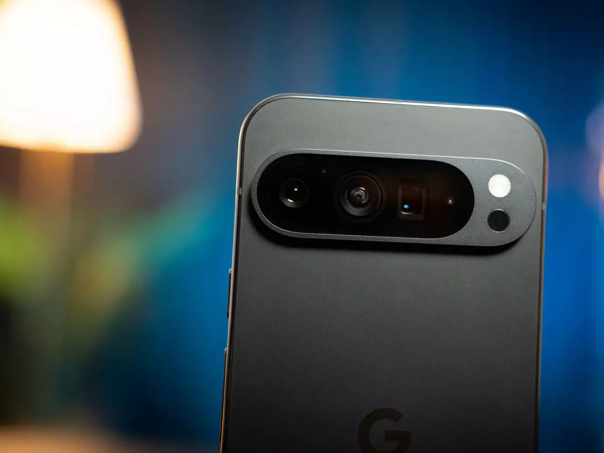 A close-up of the back of a Google Pixel 9, showing the camera module with three lenses and the Google logo.