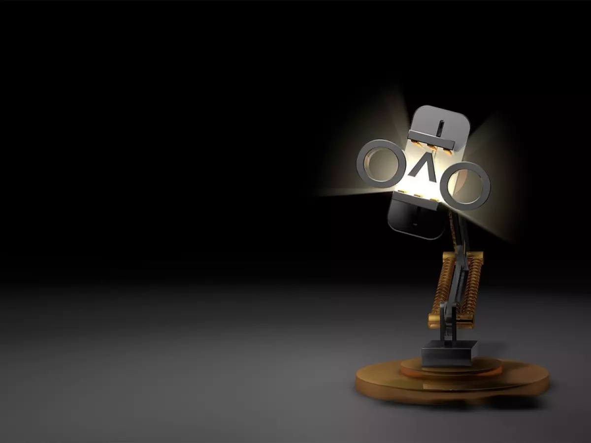 A robot arm with a light bulb on the end is standing on a dark background.