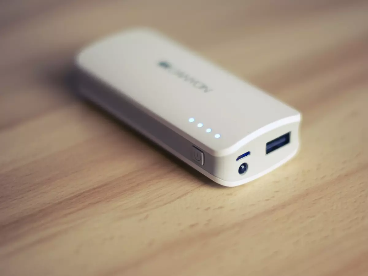 White power bank on wooden table