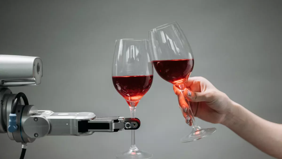 A humanoid robot hand holding a wine glass toasting with a human hand holding a wine glass.