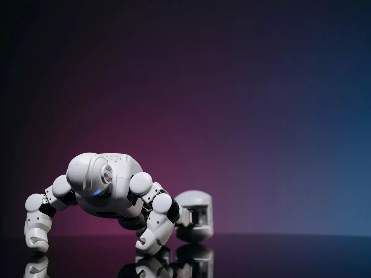 A white humanoid robot doing push ups on a reflective surface with a pink and blue background.