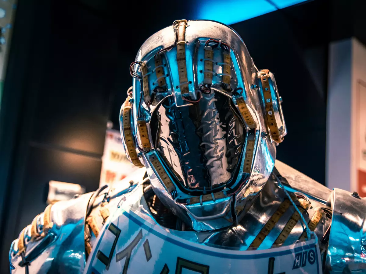 A close-up shot of a humanoid robot's head, showing its intricate metallic design and sensors.