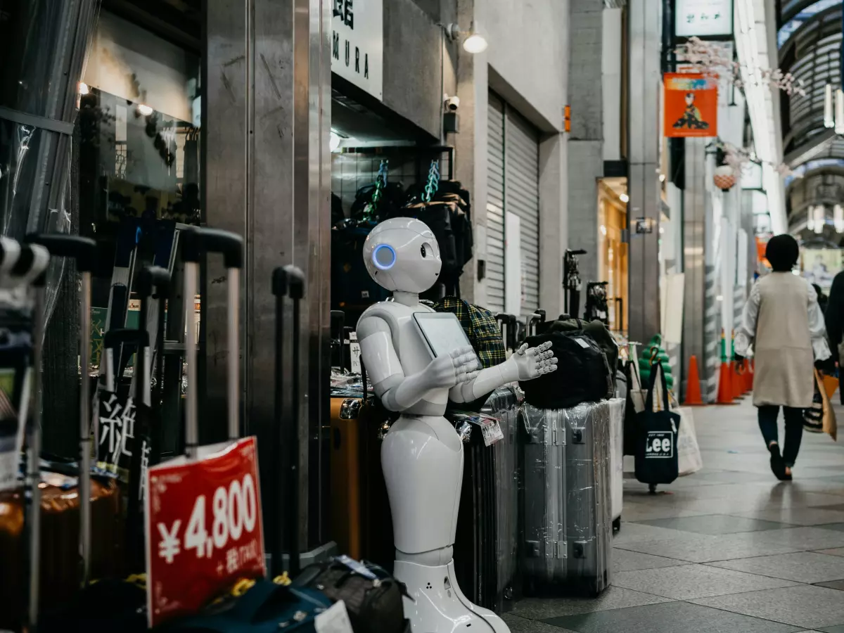 A Pudu Robotics semi-humanoid robot stands in a bustling shopping street in Japan, interacting with people and displaying its features.