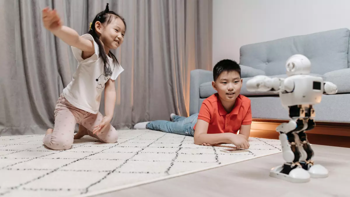 A humanoid robot interacts with two children in a living room.