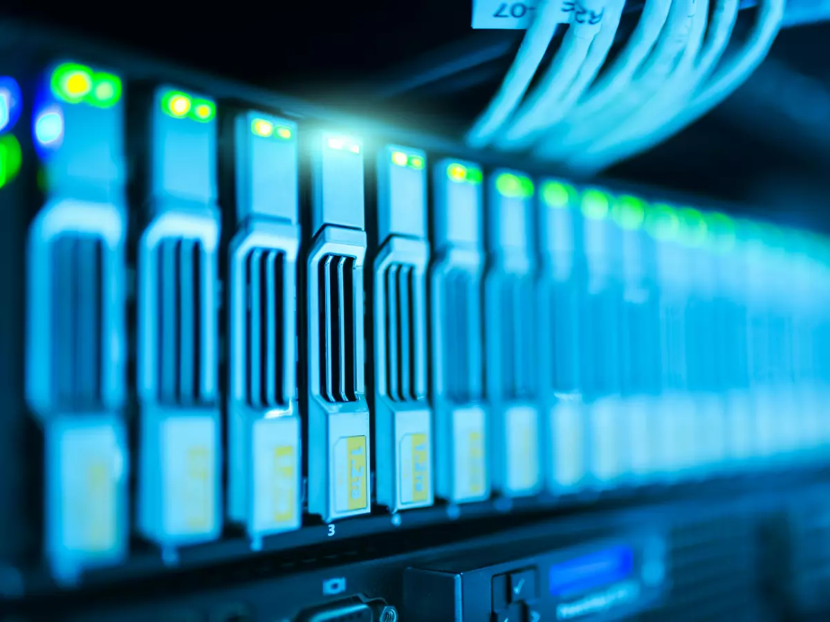 Close-up of server racks in a data center, illuminated in blue light.