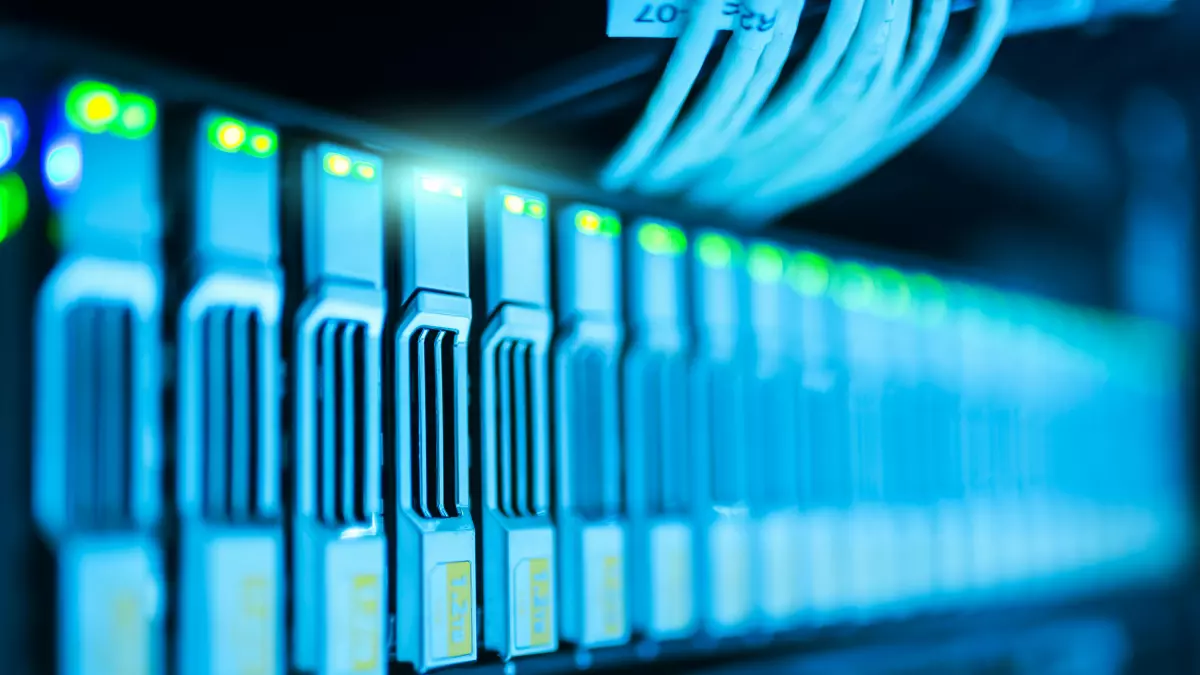 Close-up of server racks in a data center, illuminated in blue light.