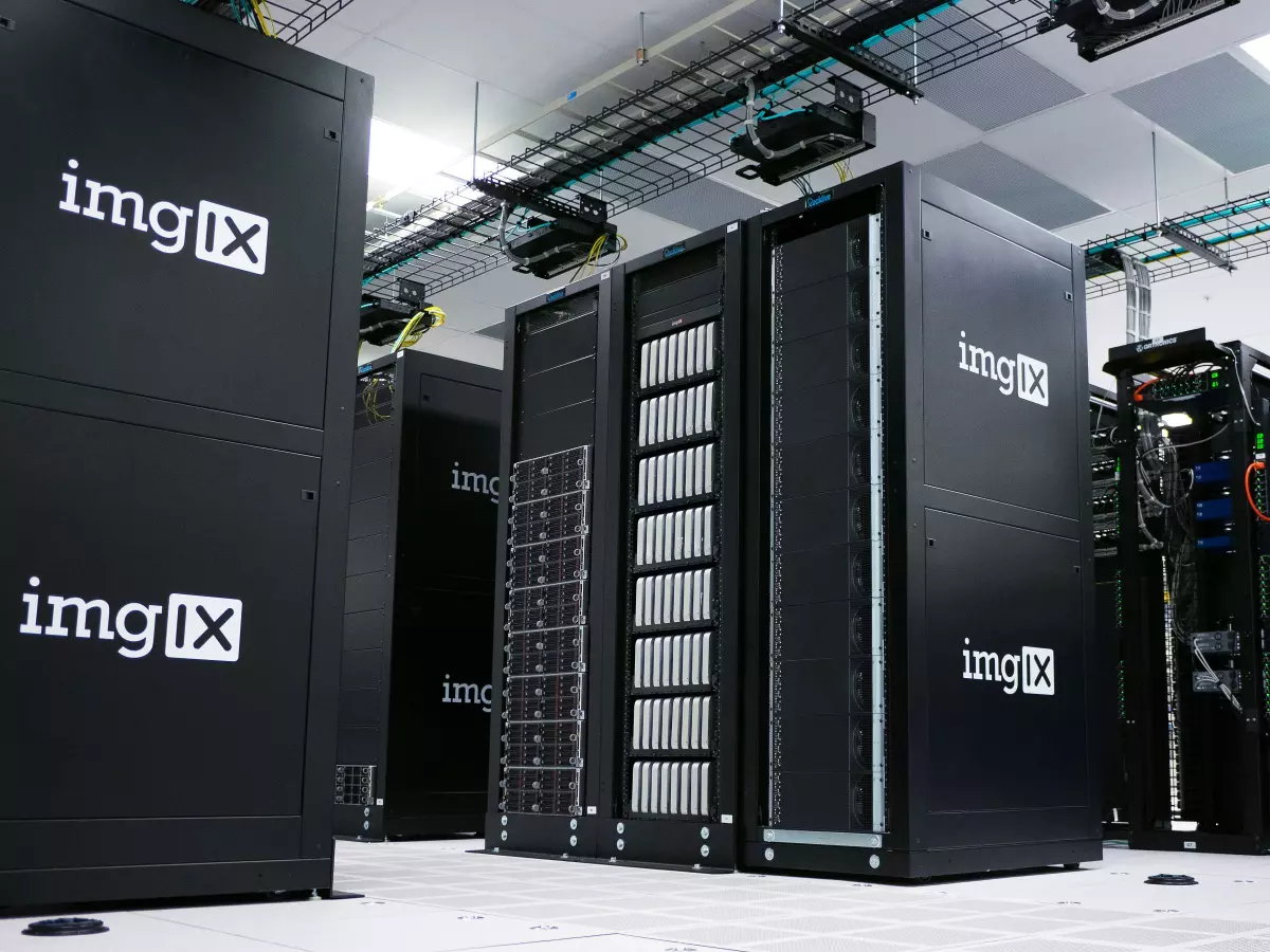 A row of black servers in a data center, with the 'imgIX' logo on each server.