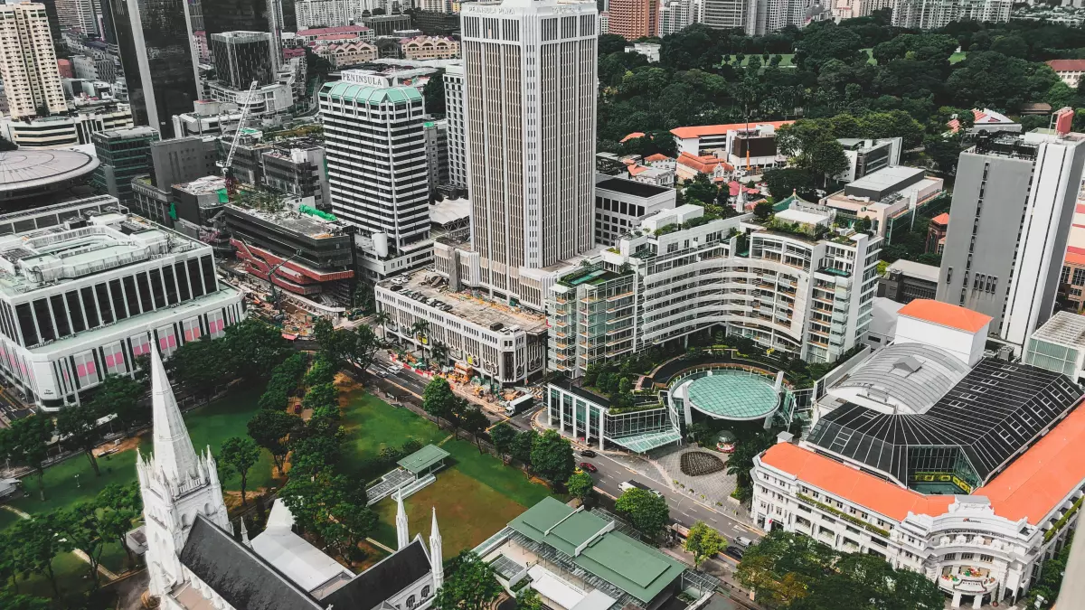 An aerial view of a city with skyscrapers and parks. 